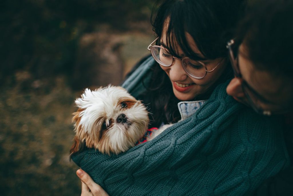 Couple gently holding their small dog