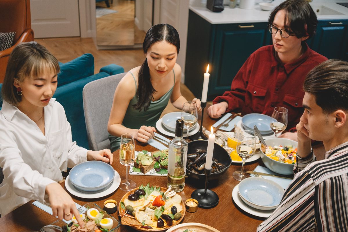 Friends sharing a relaxed candlelit dinner at home